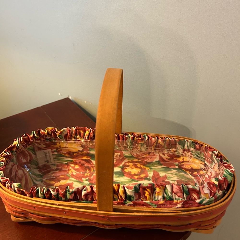 Longaburger basket with handle Lined with floral design and plastic liner